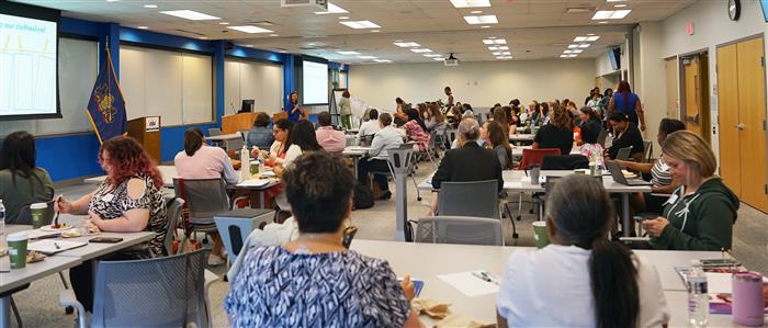 Attendees sit at their tables at an event at the AIU.
